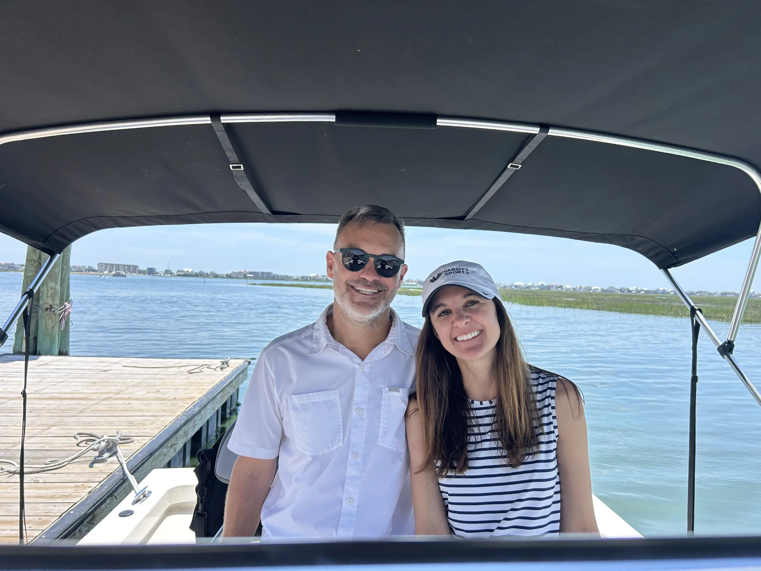 Pair posing under boat canopy
