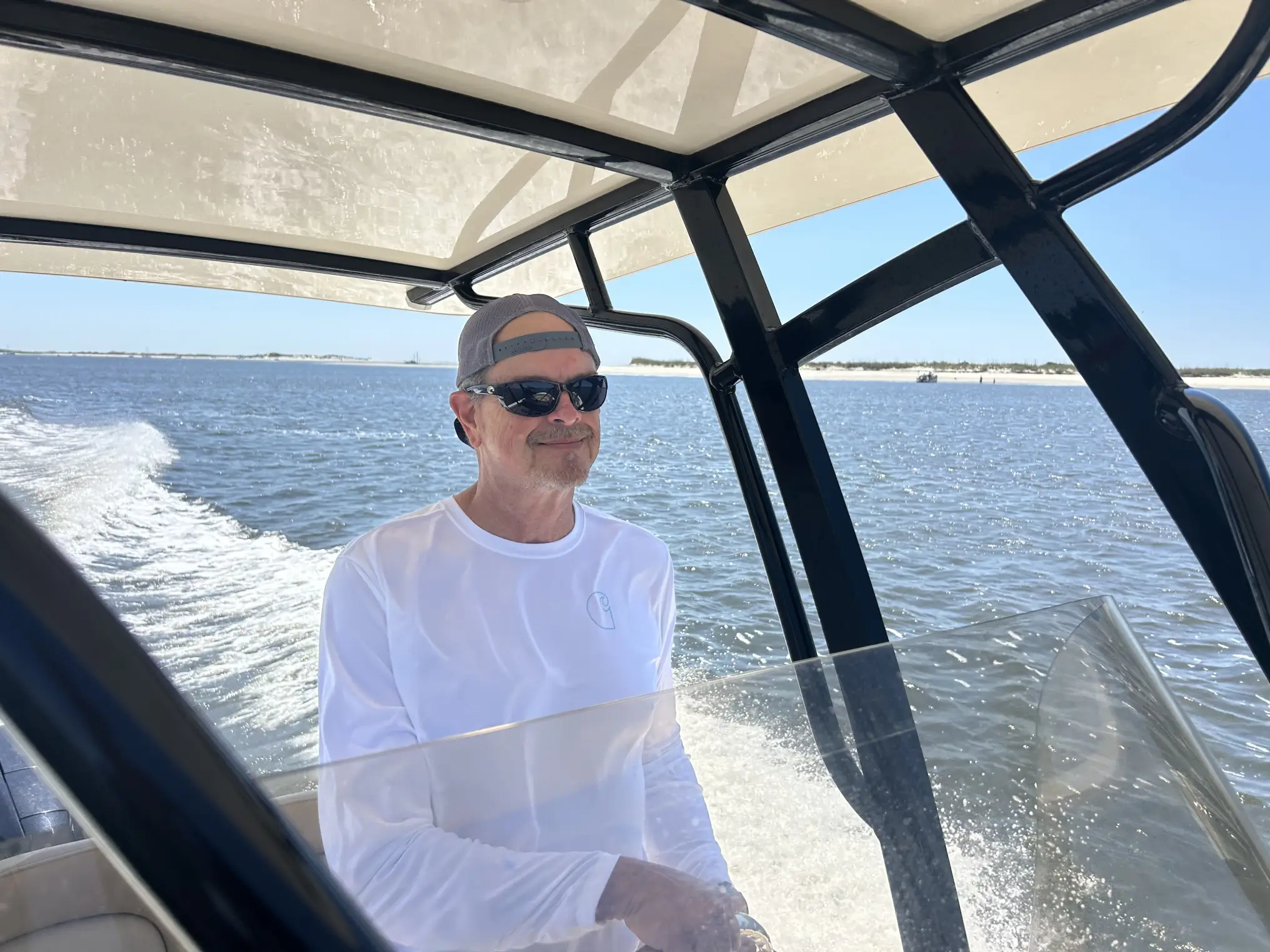 Smiling man steering boat on water