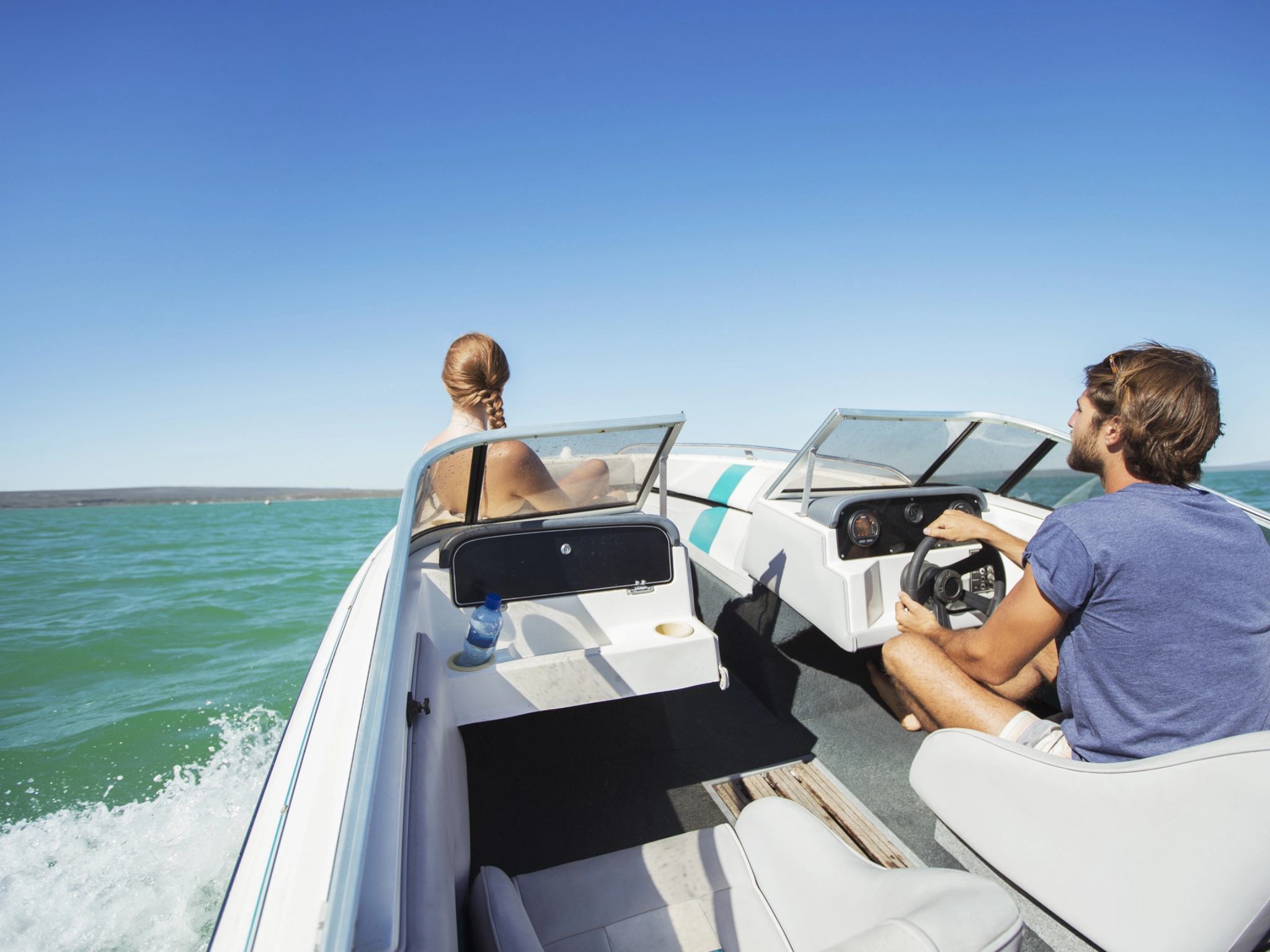 Couple enjoying a recreational boat ride.