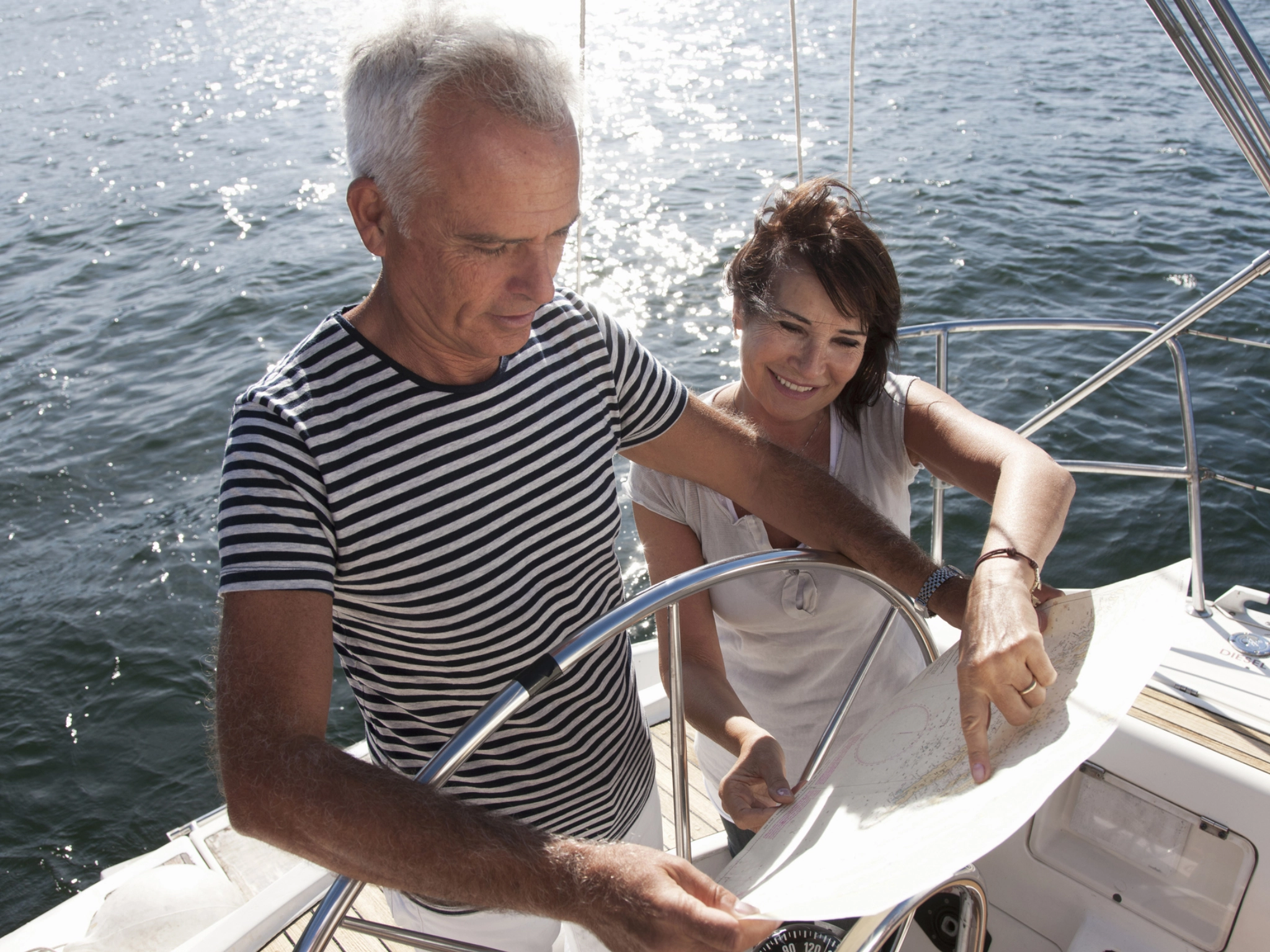 People sailing and checking navigation chart