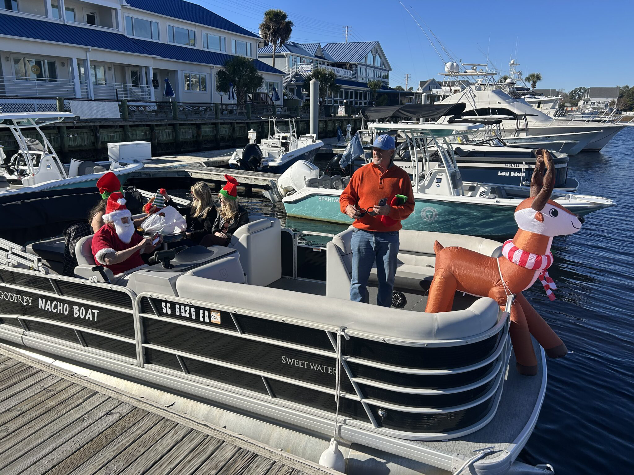 People in Santa hats on a boat