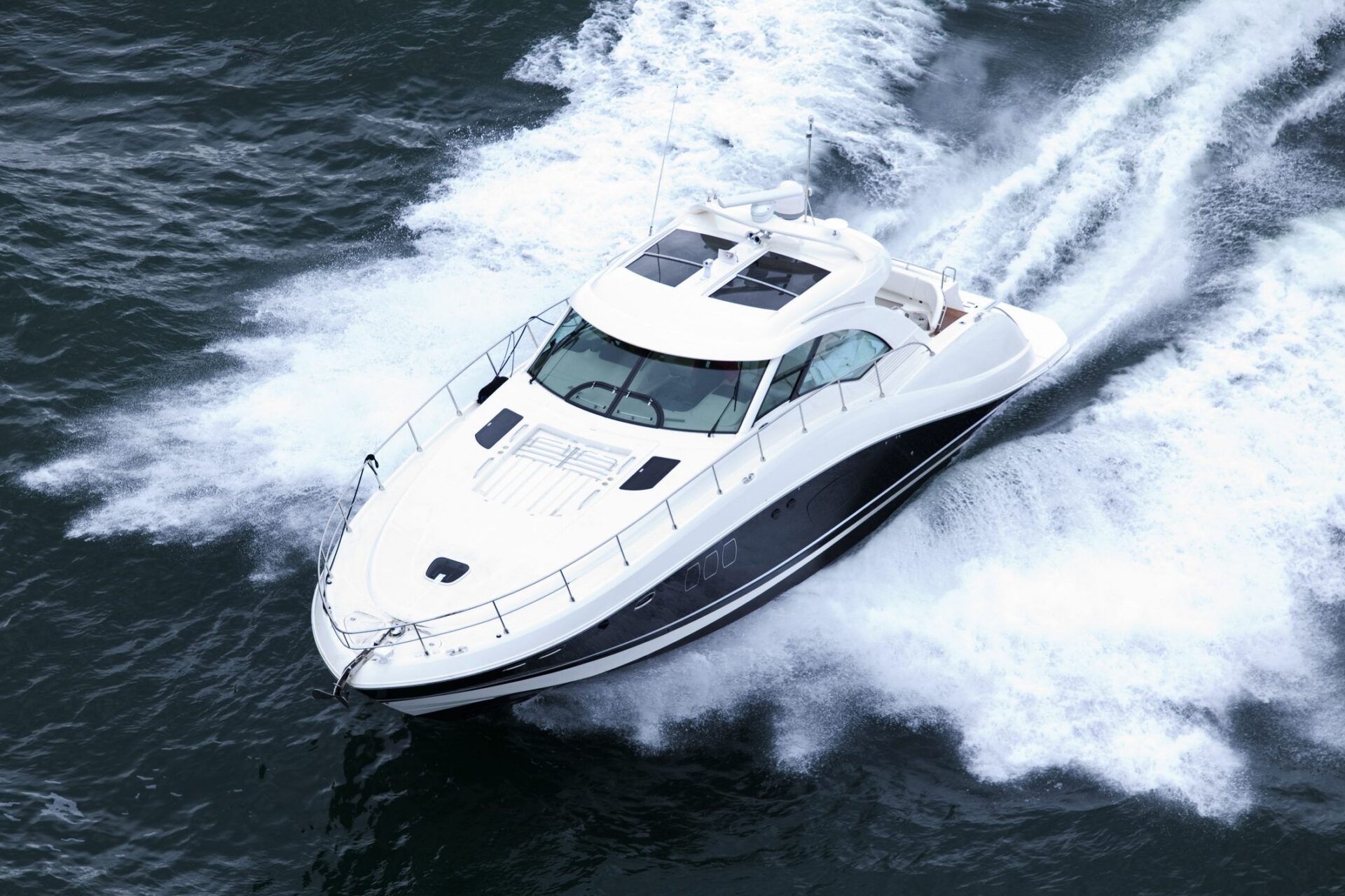 White yacht speeding through the water.