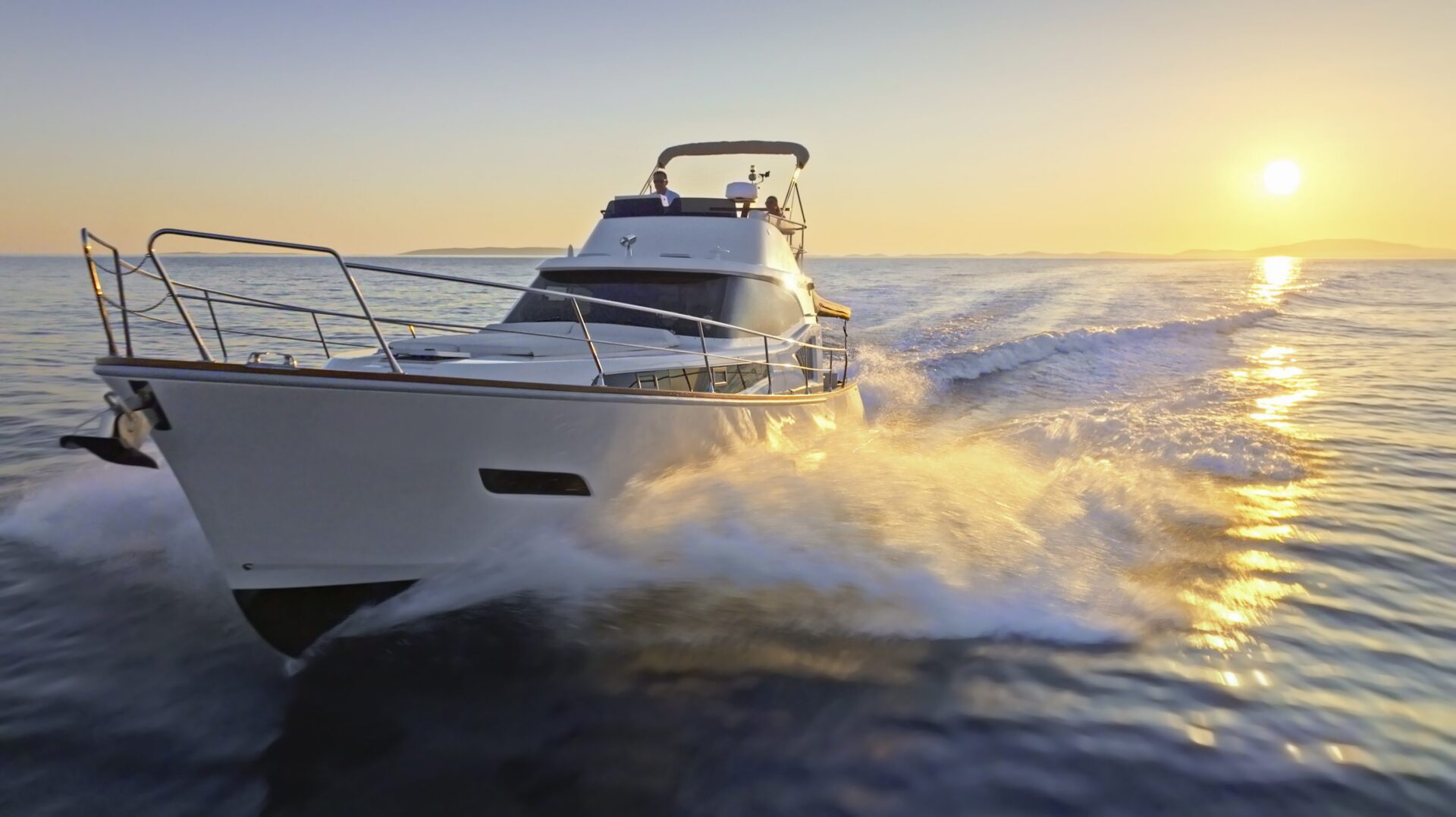 Boat cruising on water at sunset.