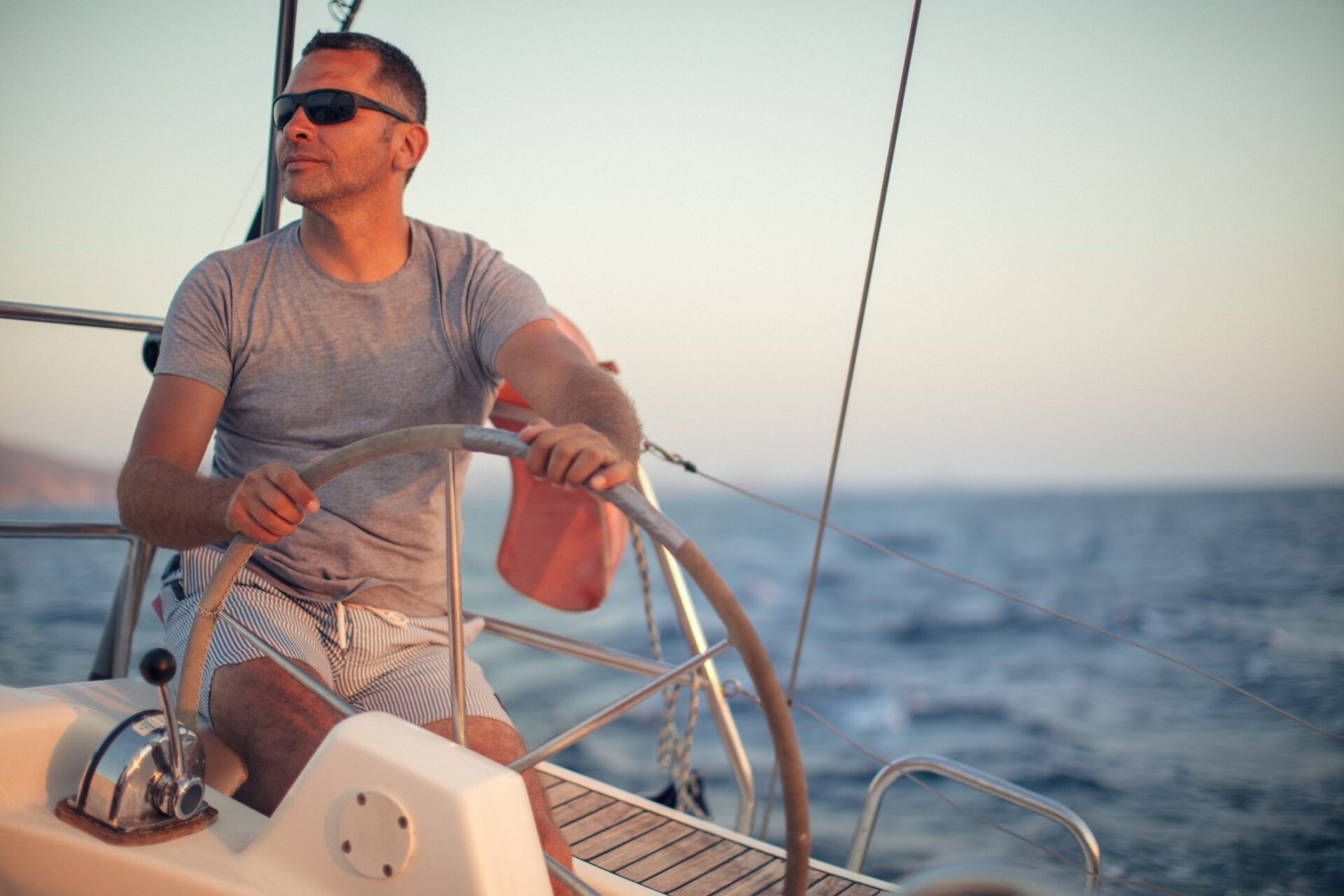 Sailor navigating ocean waters in sunlight