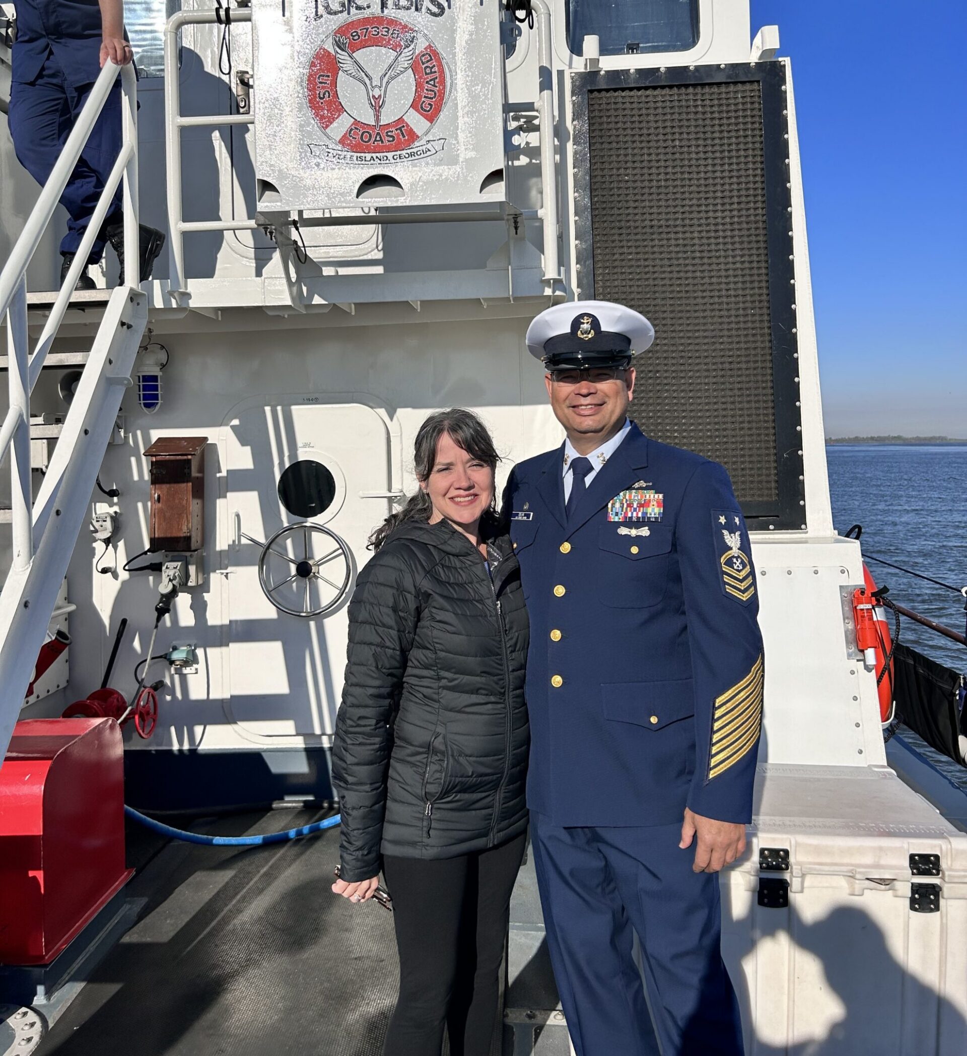 Two people posing on a ship deck.