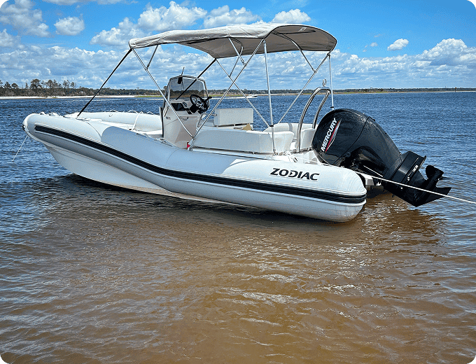 White Zodiac boat on calm water
