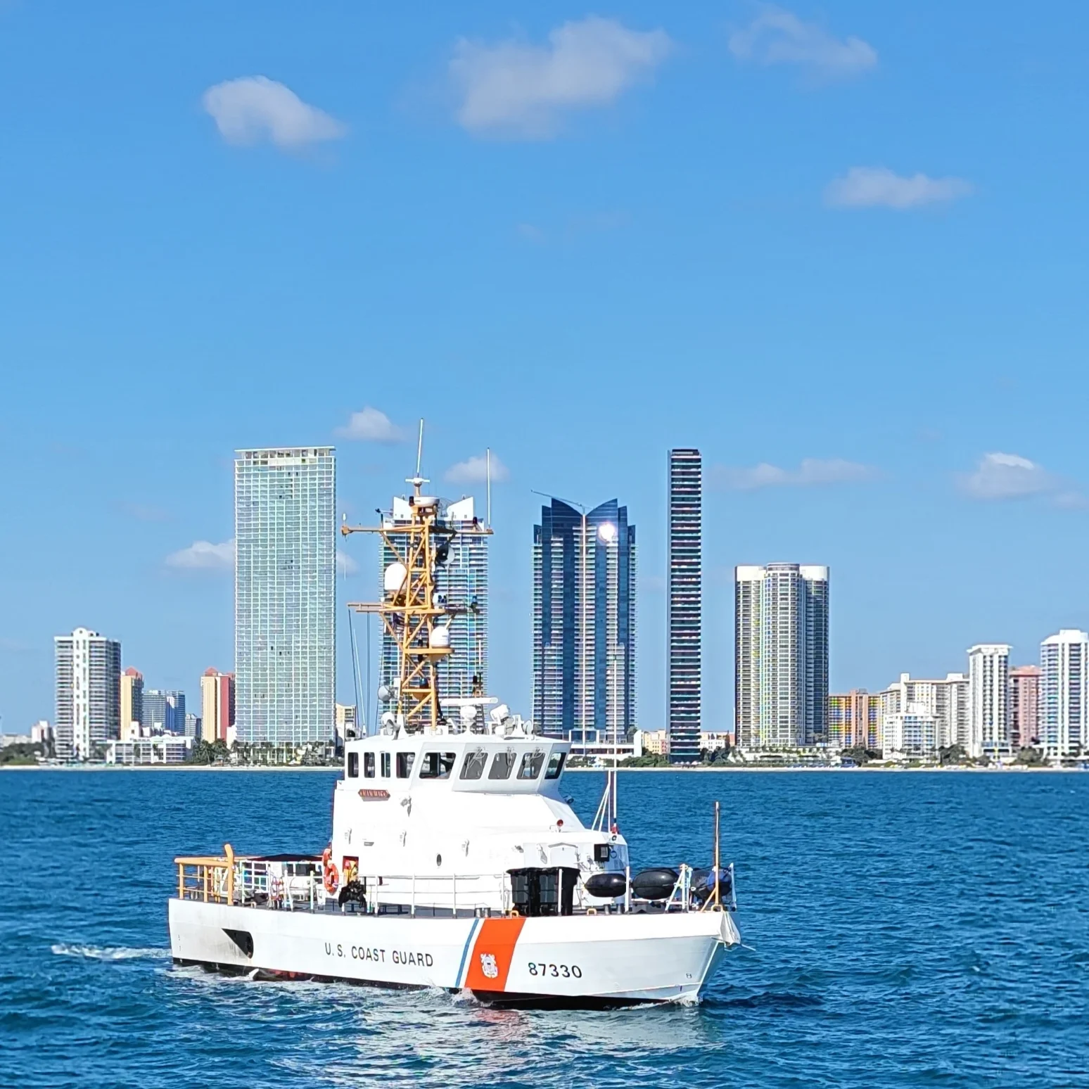 Coast Guard ship near city skyline