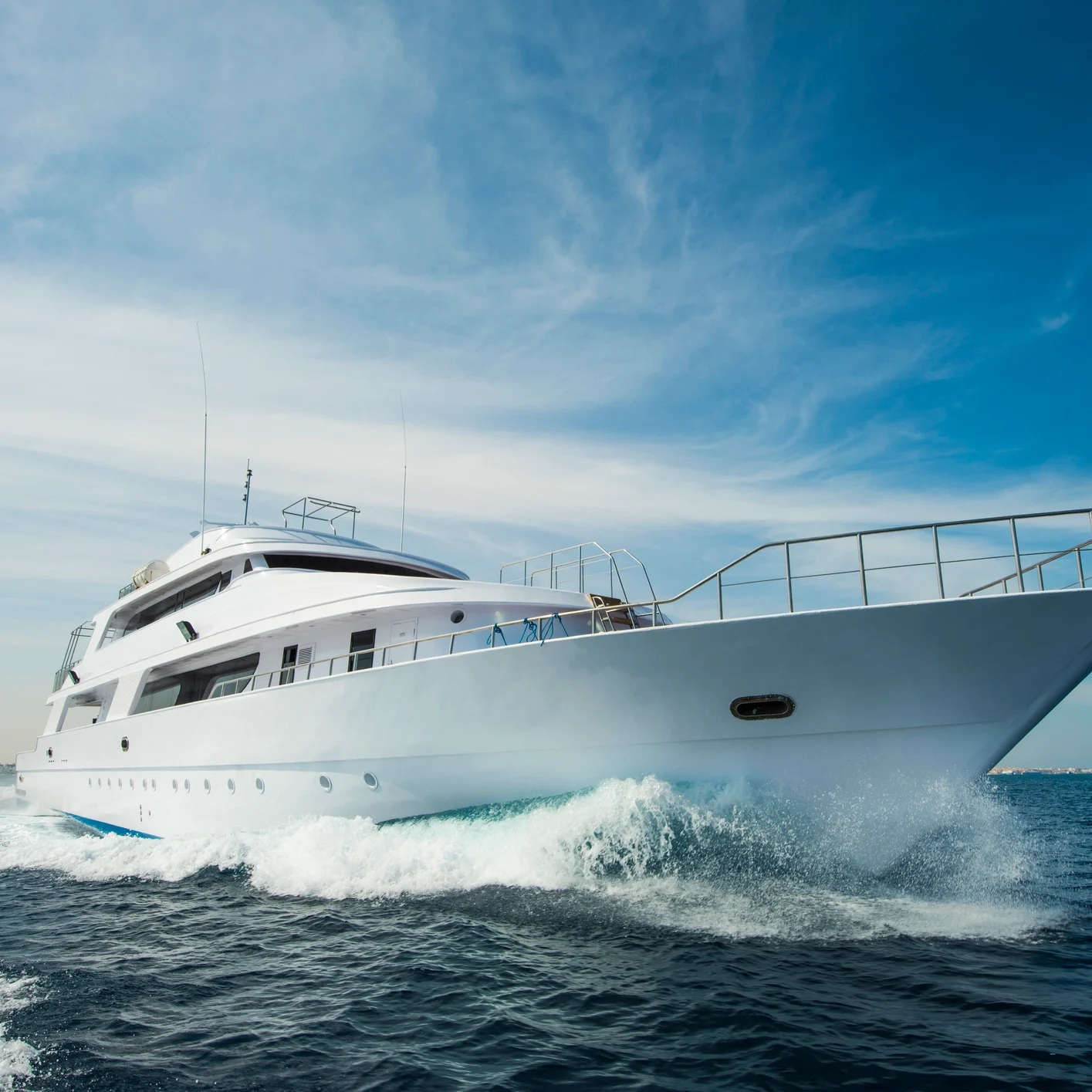 Luxury yacht cruising on open sea.